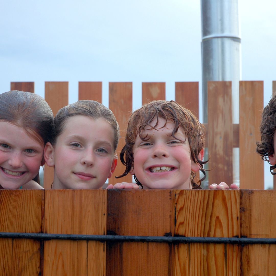 Children smiling in hot tub