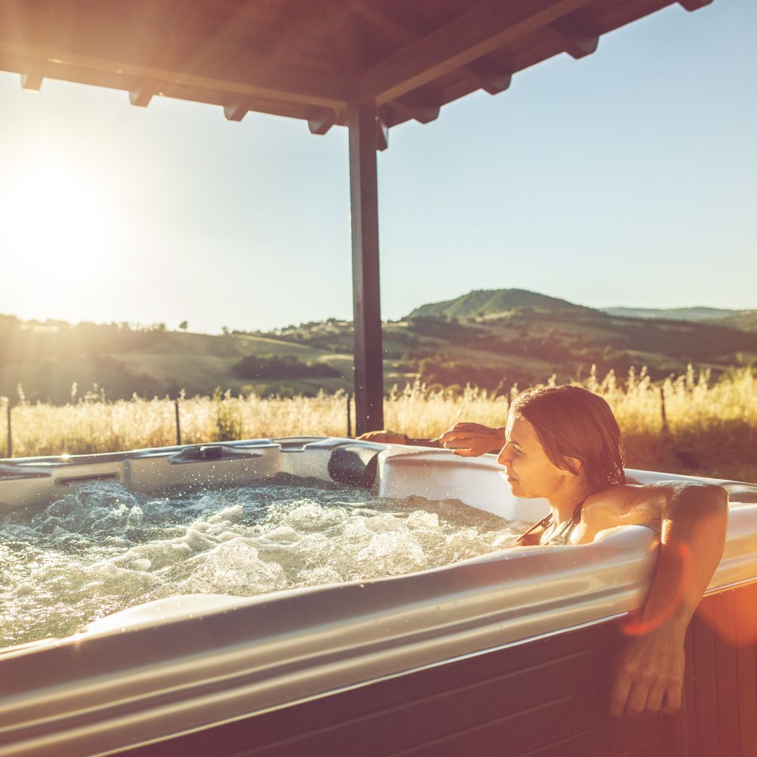 Woman relaxing in hot tub in the sun