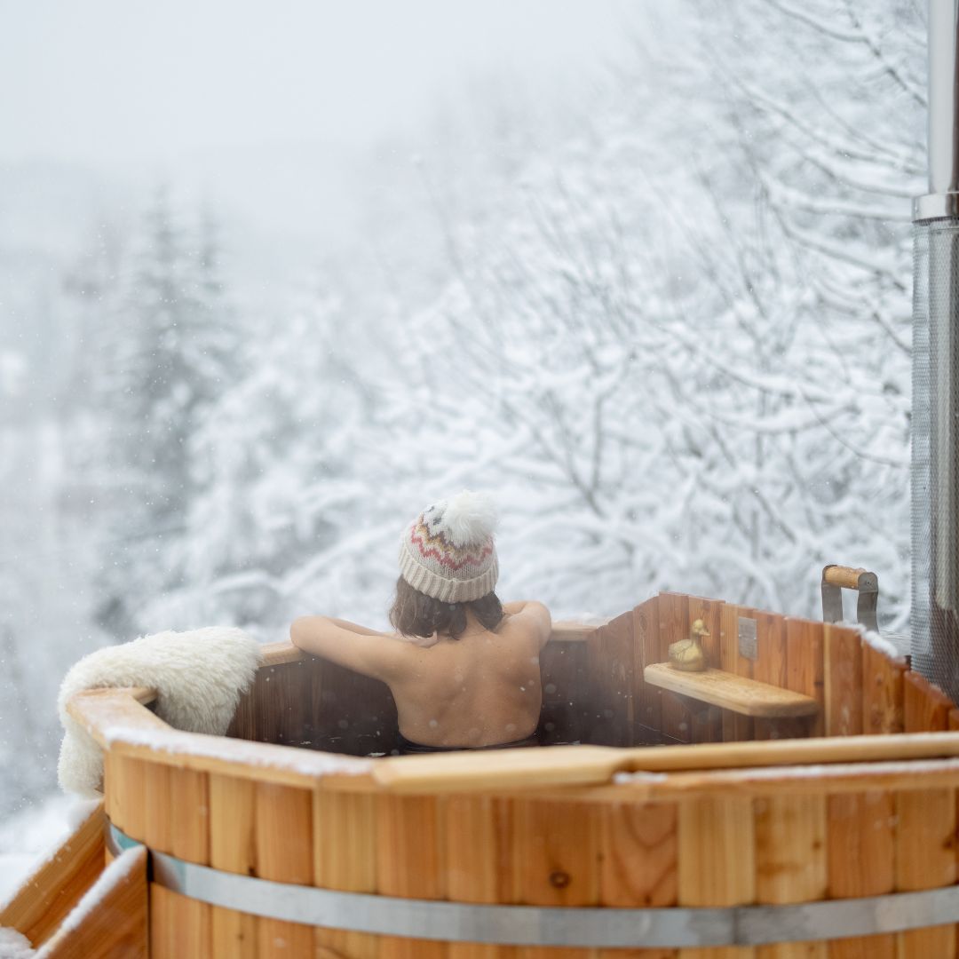 Woman relaxing in hot tub during winter