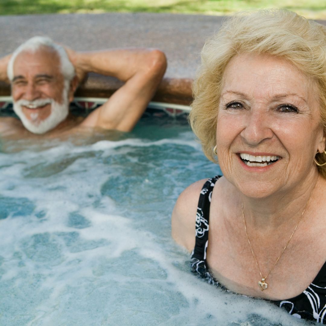 Senior couple smiling in hot tub