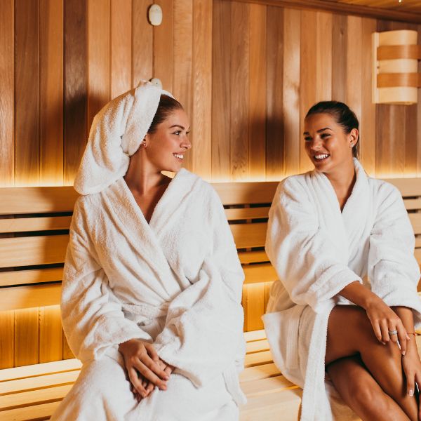 Two women sitting in a sauna 