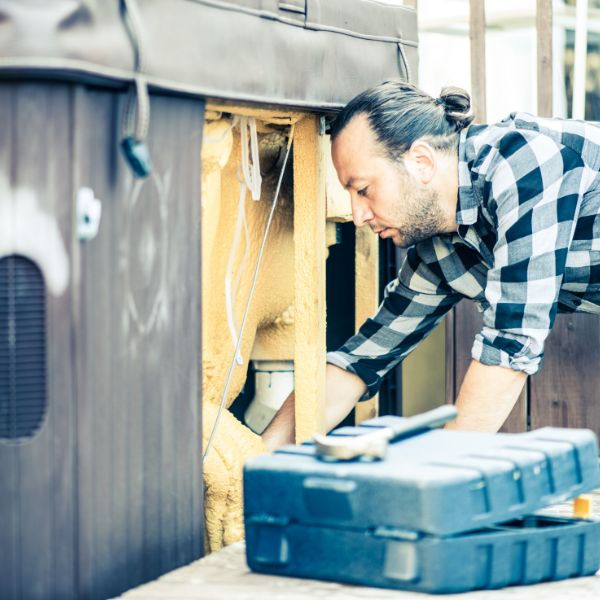 A man installing a hot tub