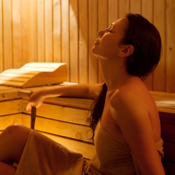 Woman sitting in a sauna