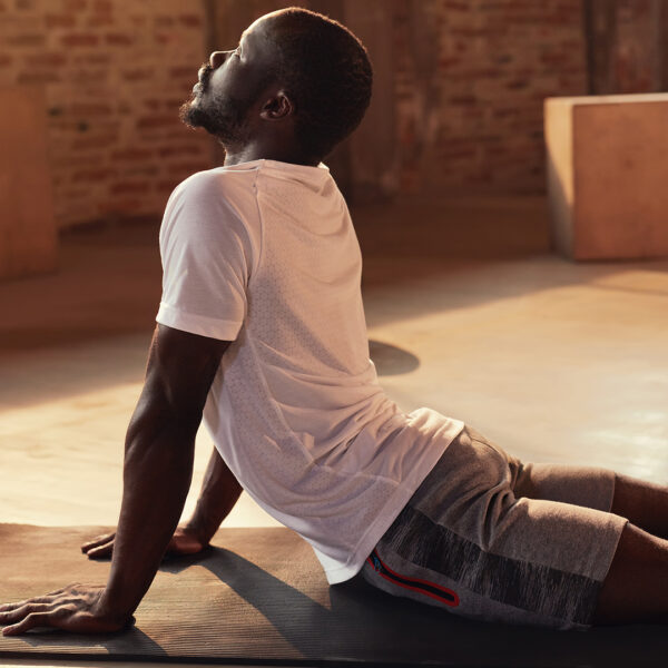A man stretching on a yoga mat