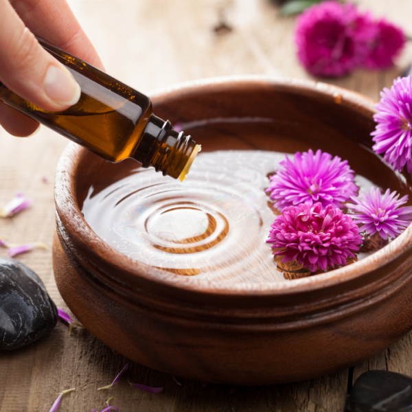 essential oils being poured into a bowl