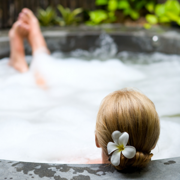 A woman relaxes in a hot tub