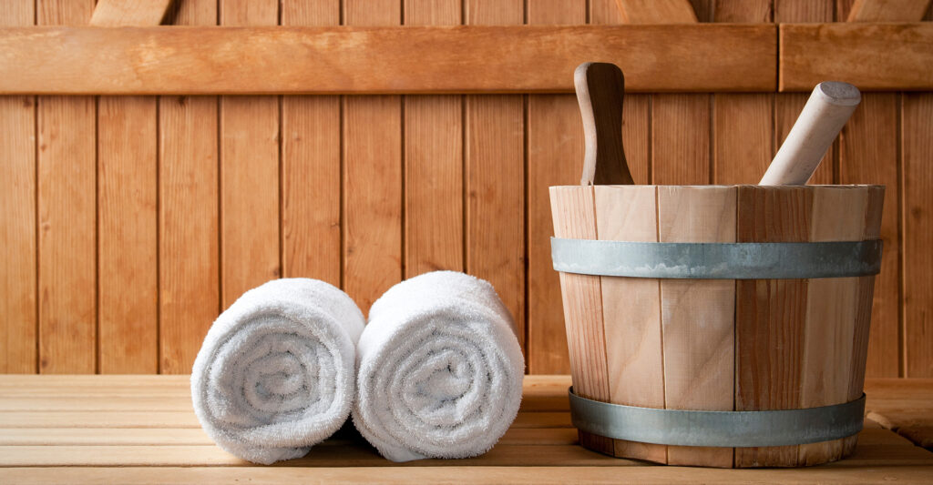 a bucket and towels in a wooden sauna