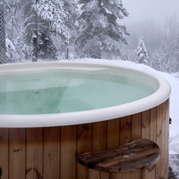 A hot tub outside in a snowy background