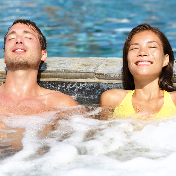 A couple relax in a hot tub