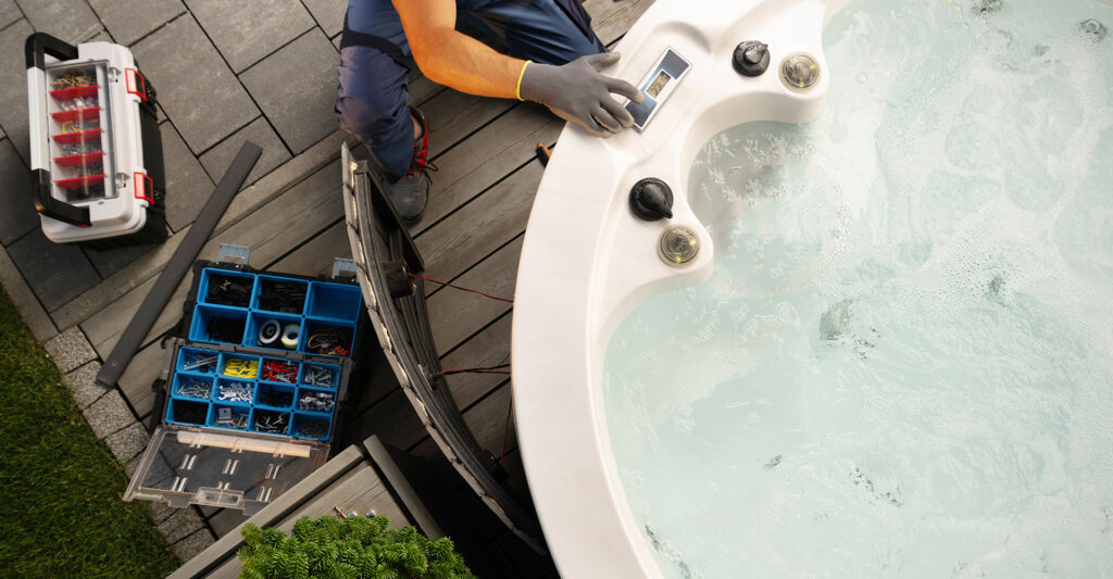 A worker doing maintenance on a hot tube